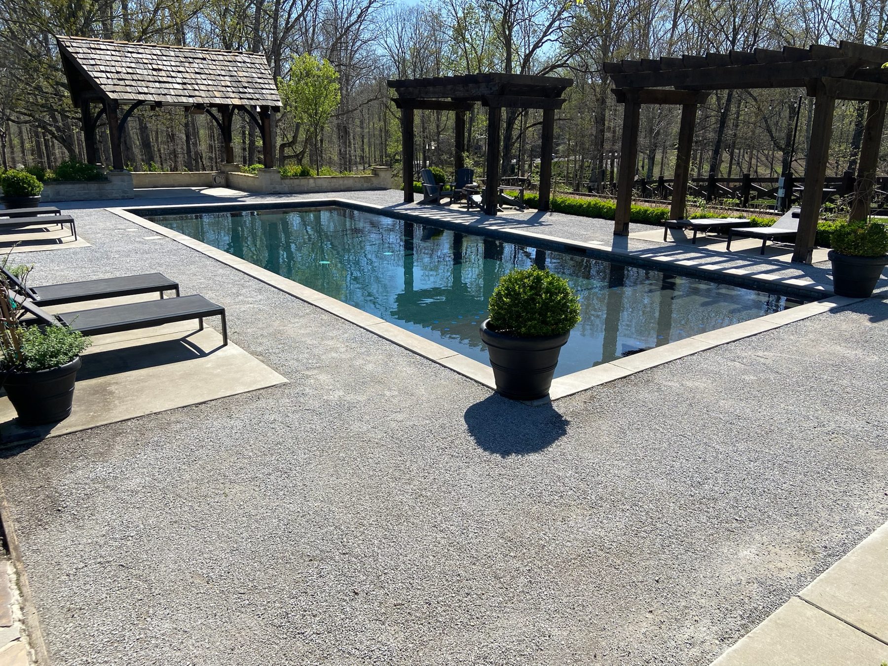 Custom inground pool with pergola and pool deck by Rios Landscaping in Middle Tennessee
